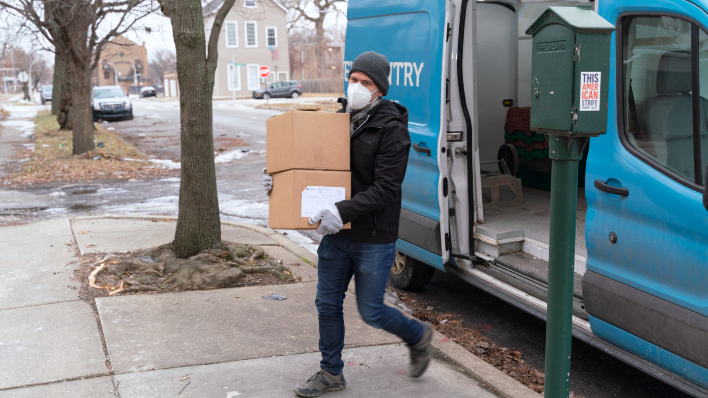 Lance Aguilar, a driver for Lakeview Pantry, unloads boxes of groceries at the Primo Center shelter in Englewood. 