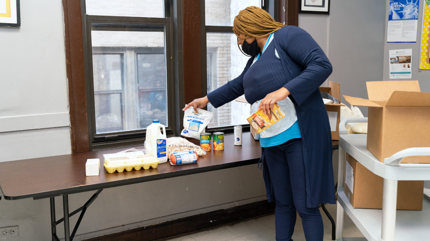 Shanece, a mother of three young children, unpacks groceries received from the Pantry's online market program. 
